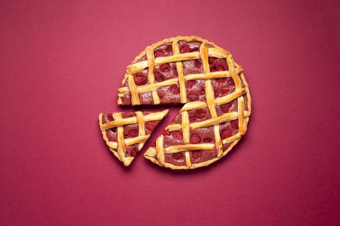 Raspberry pie with a lattice crust and one slice. Summer dessert
