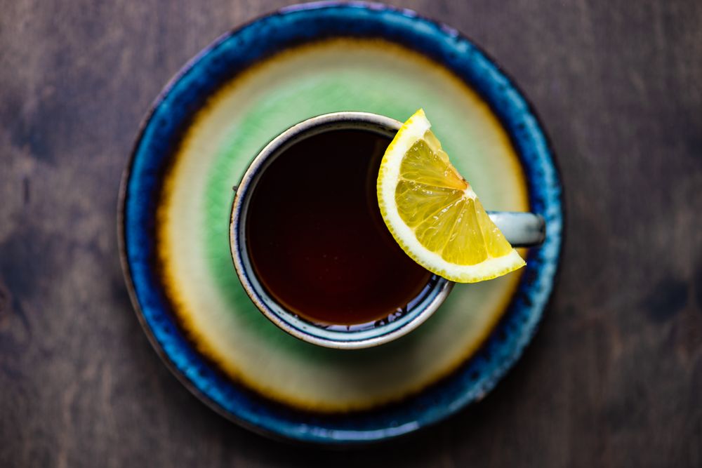 Cup and saucer of tea and slice of lemon