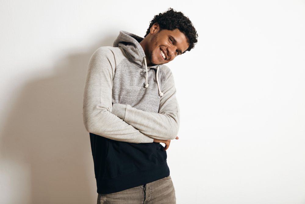 Man smiling with arms crossed