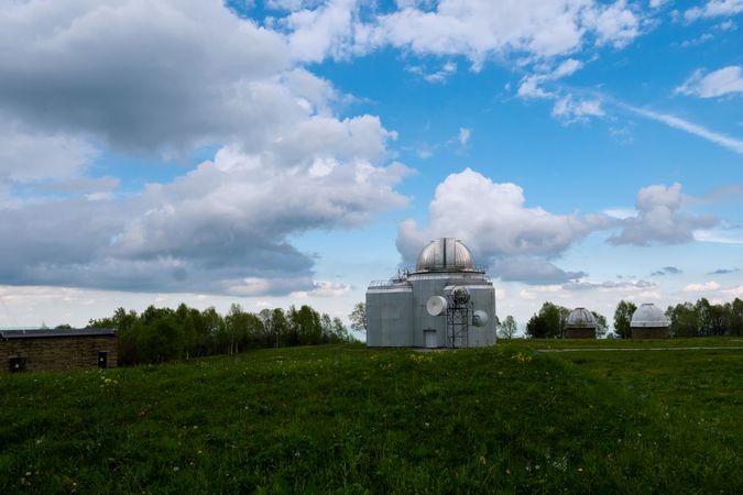 Multiple observatory domes on grassy hill