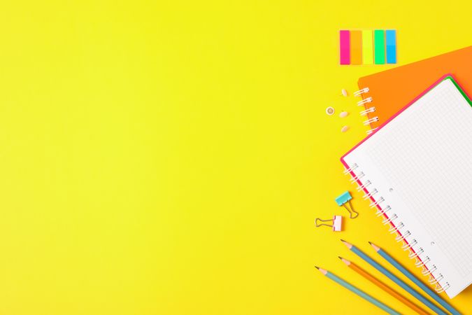 Flat lay composition with school supplies on color background, space for text