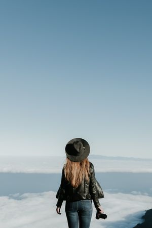 Woman with camera enjoying cloudscape