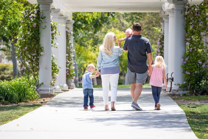 Young Family Taking A Walk In The Park