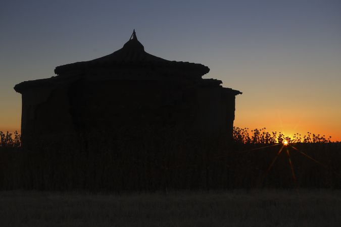 Aged house in rural countryside under starry sky