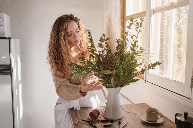 Young woman with bouquet at home