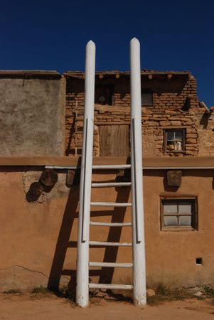 Historic Acoma Pueblo adobe house with ladder
