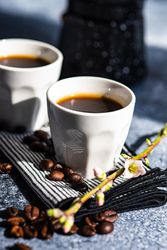 Cups of espresso on napkin on counter