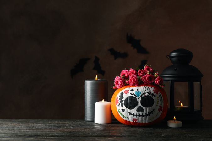 Pumpkin with catrina skull makeup and halloween accessories