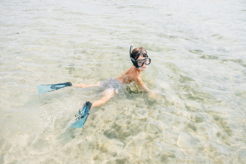 Kid swimming in diving mask