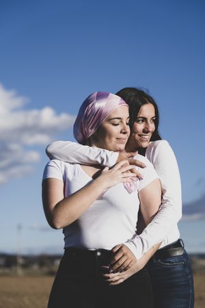 Two young woman with cancer bandana