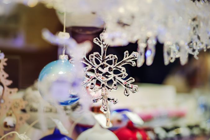 Glass snow flake decoration for sale in Christmas market in Strasbourg, France