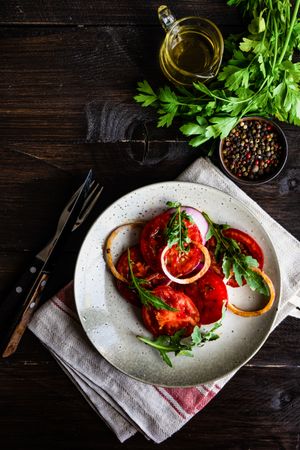 Top view of healthy tomato salad on wooden table on copy space