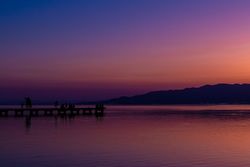 Sunset on a sea walkway with people