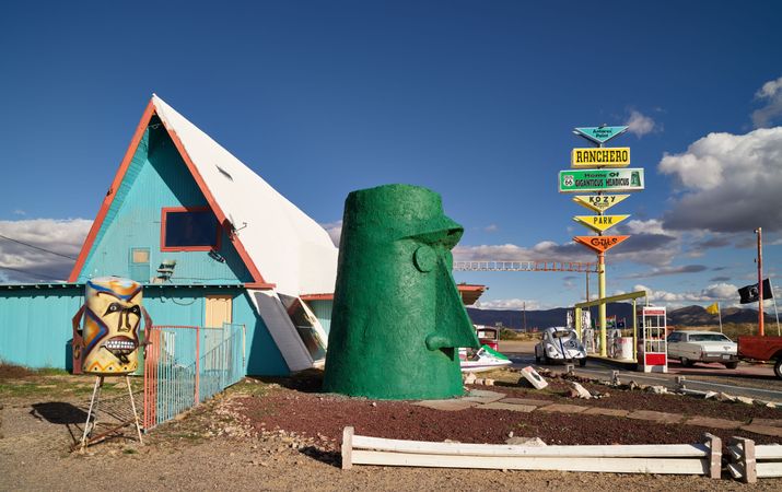 Quirky green Moai and tiki sculptures at roadside attraction in Arizona