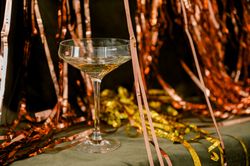 Champagne for new year greetings green and gold background