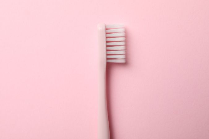 Toothbrush on pink background, close up. Dental care