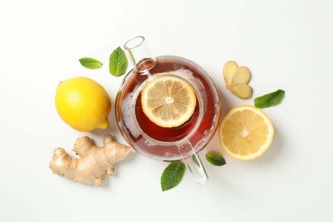 Flat lay. Teapot, lemon, mint and ginger, space for text