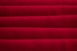 Close up Red folded Fabric Background Texture.