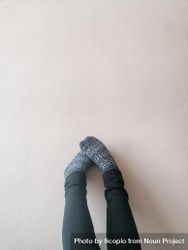 Two feet in gray socks on the wall 49pEa5