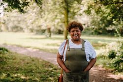 Smiling mature woman on path in green park