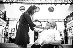 MONTREAL, QUEBEC, CANADA – March 16 2019- Woman stands holding the face of a man in a wheelchair