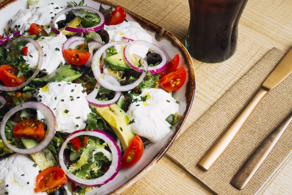 Vegetables salad with onion greens and cream sauce