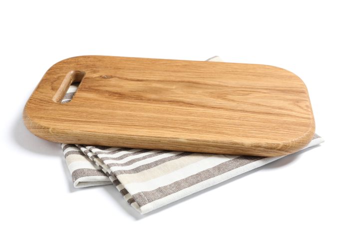 Cutting board with kitchen towel isolated on tudio background