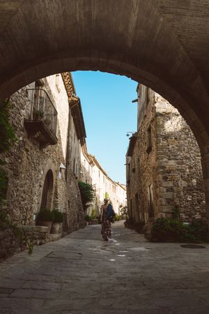 Woman walking in a narrow path in a village