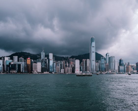 Hong Kong cityscape under cloudy sky