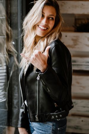 Casual stylish woman standing at table in cafe