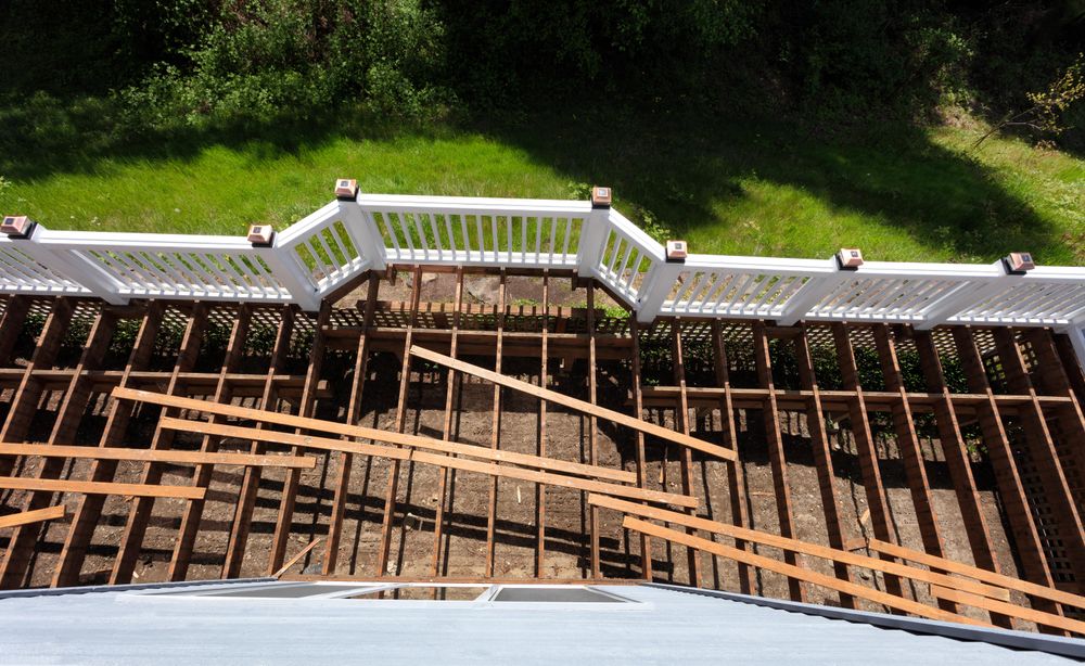 Top view of an aged outdoor wooden deck being tore down due to weathered boards