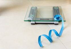 Weight scale and tape measure on bathroom