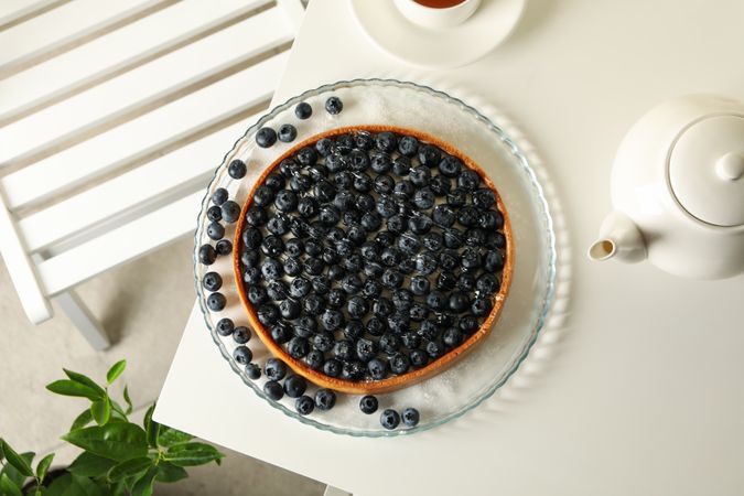 Concept of tasty breakfast with blueberry pie on table