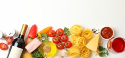 Composition with pasta and ingredients for cooking on plain background, top view