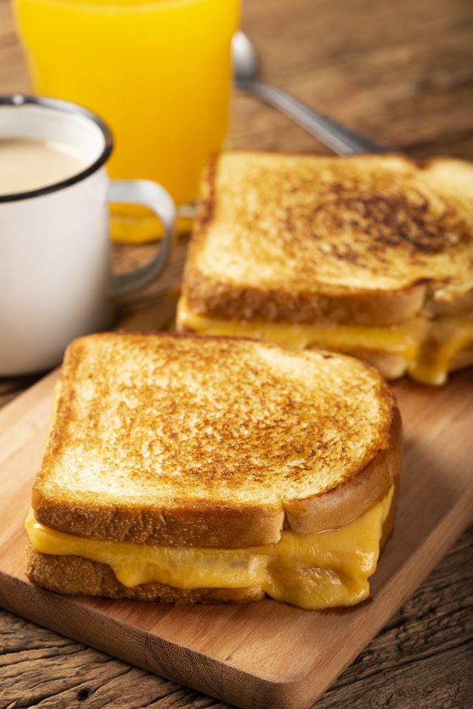 Grilled ham and cheese. Sandwich with cheese and ham on grill.