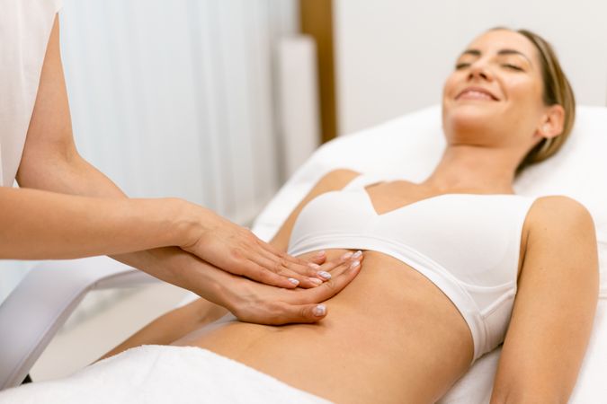 Relaxed female having a lymphatic massage at spa