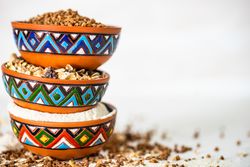Side view of colorful bowls full of different grains