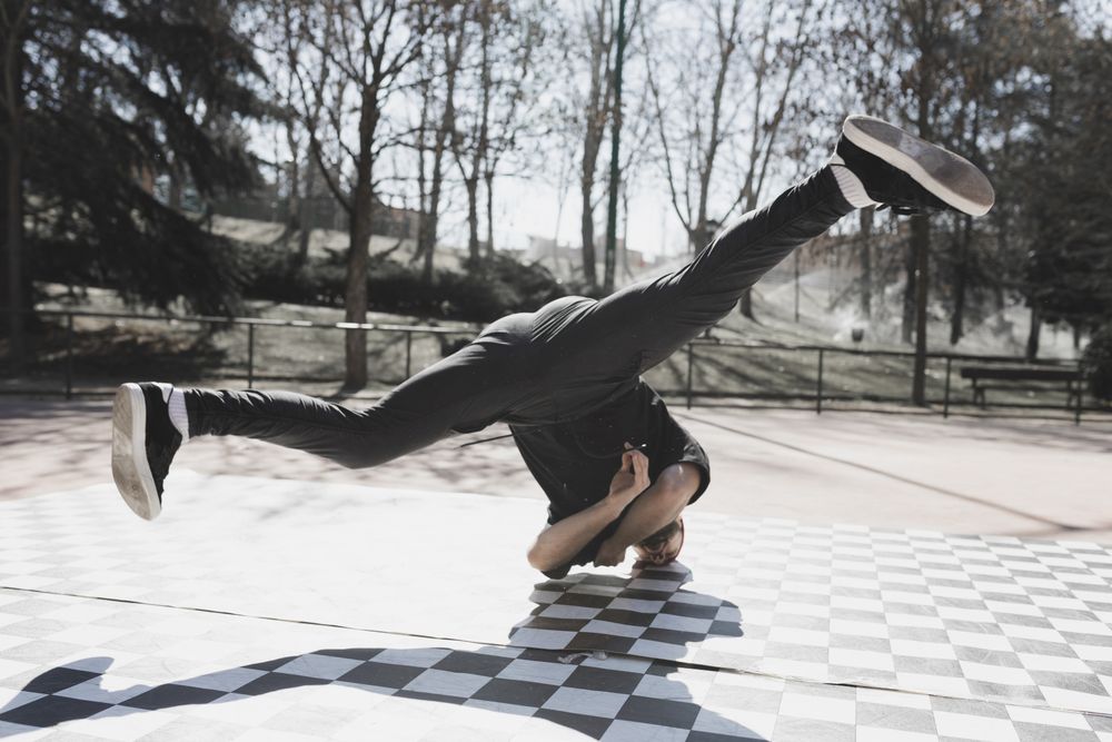 Man dancing break dance in park