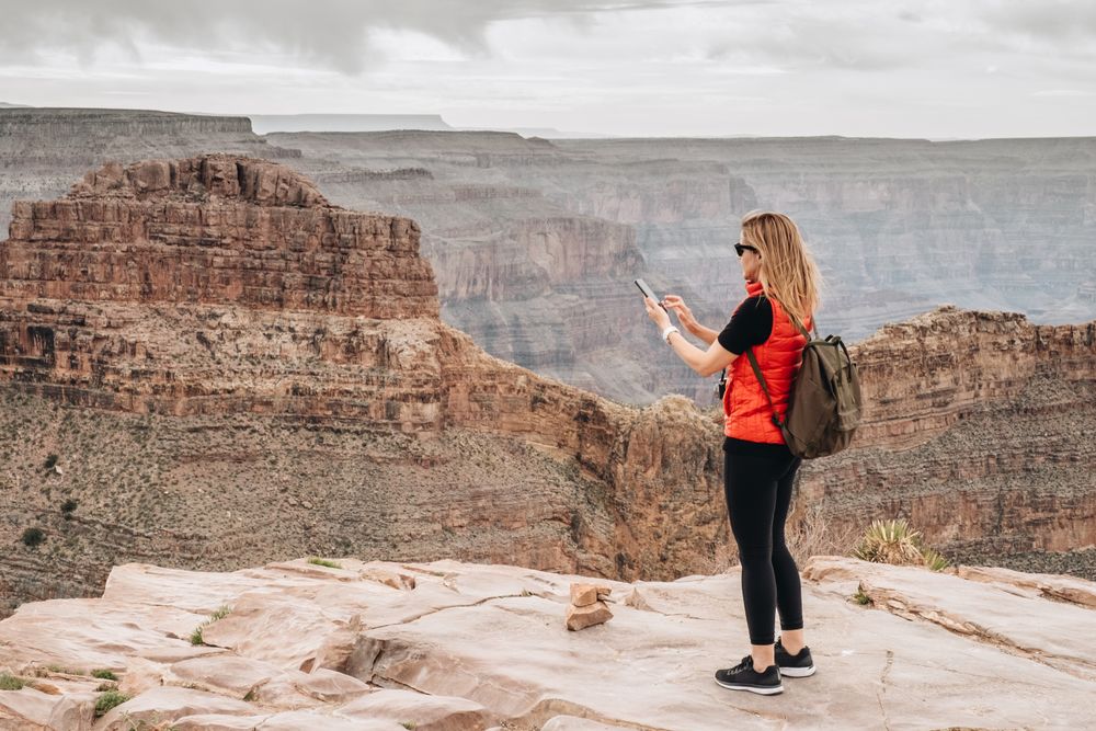 Active female photographing pictorial landscape