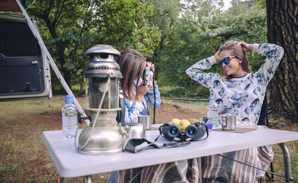 Woman taking photo to friend with hands in head