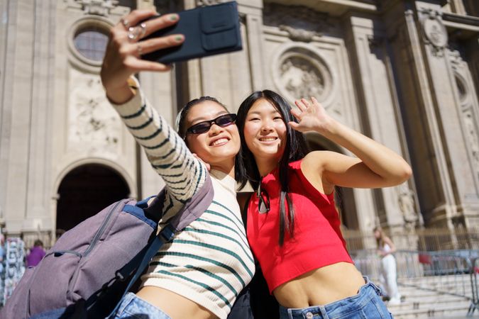 Two women taking selfie in front of Church in Spain