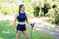 Woman doing resistance training in park