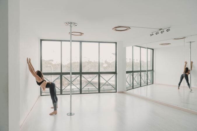 Flexible woman stretching in studio