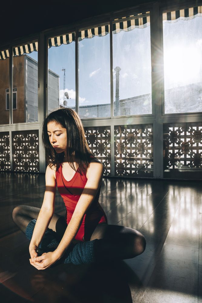 Content woman flexing body in studio
