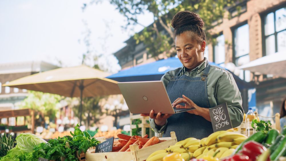 Portrait of a Black Female Running a Street Vendor Food Stand with Fresh Organic Agricultural Products.