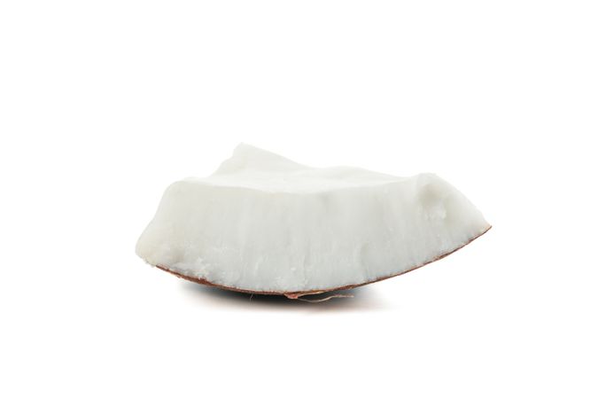 Coconut piece isolated on plain background. Tropical fruit