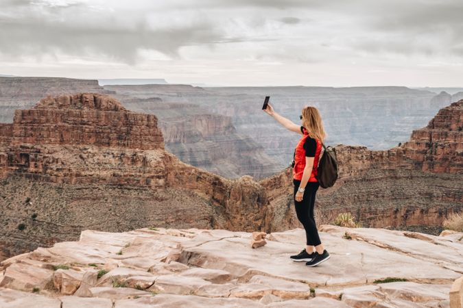 Active female photographing pictorial landscape