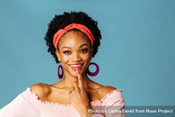 Studio shoot of smiling Black woman with finger on her mouth 0KnAyb