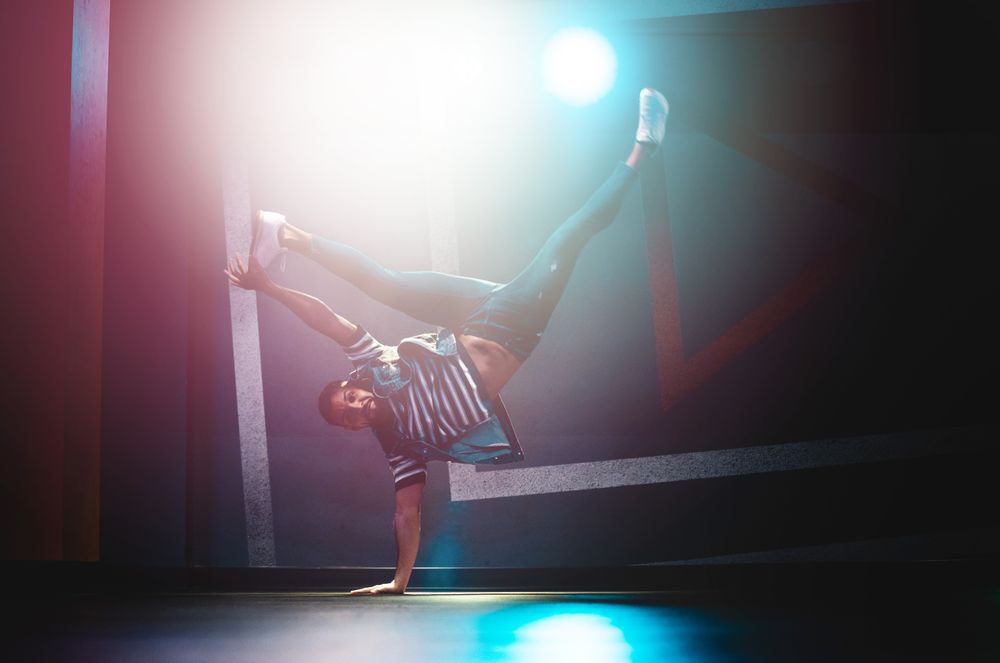 Man performing dance in spotlights