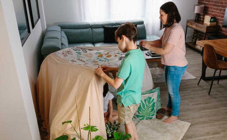 Family preparing tent to camping at home